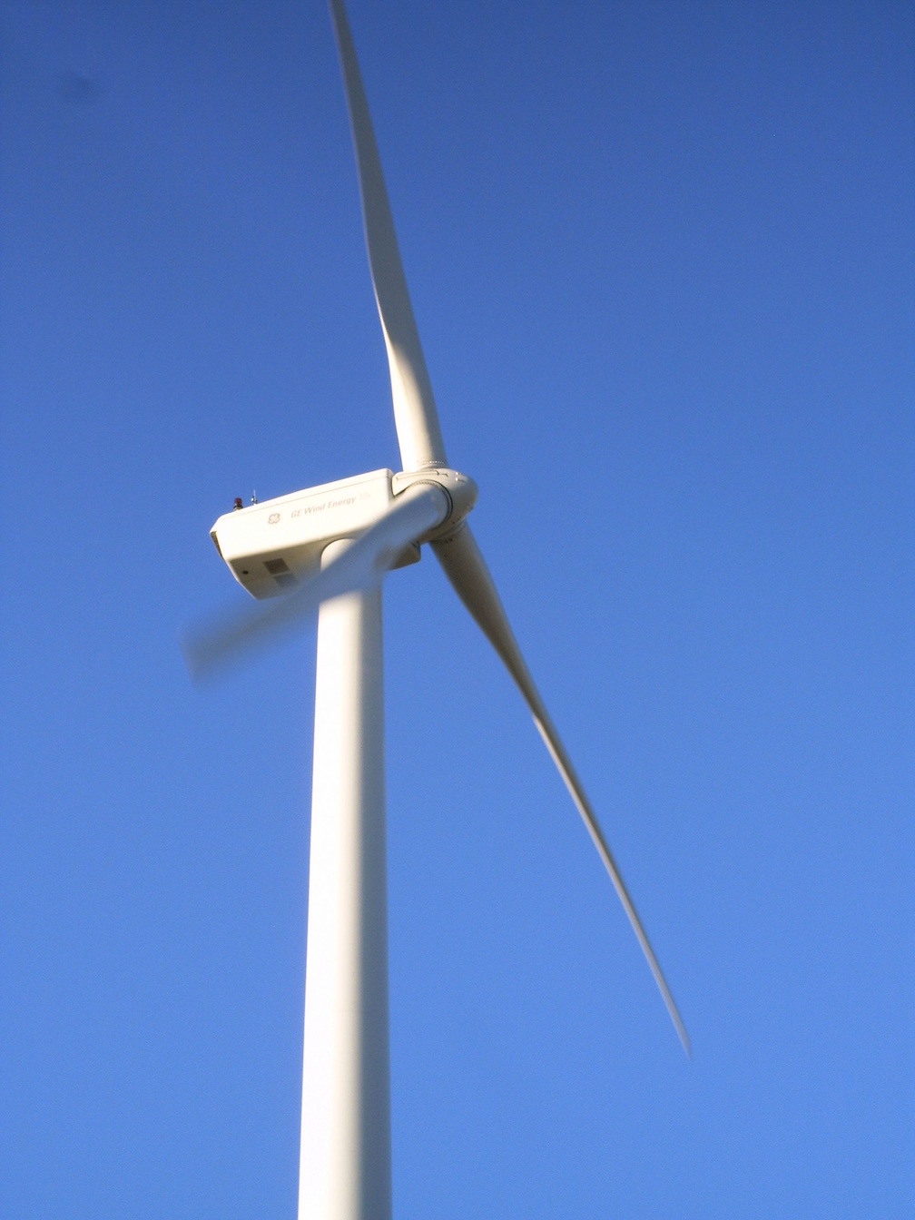 Wind turbines in sun glow